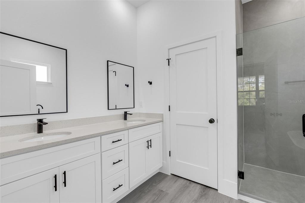 3428 Southwest 165th Loop Ocala, FL 34473 - Photo 27 of 43 a bathroom with double sink and a mirror