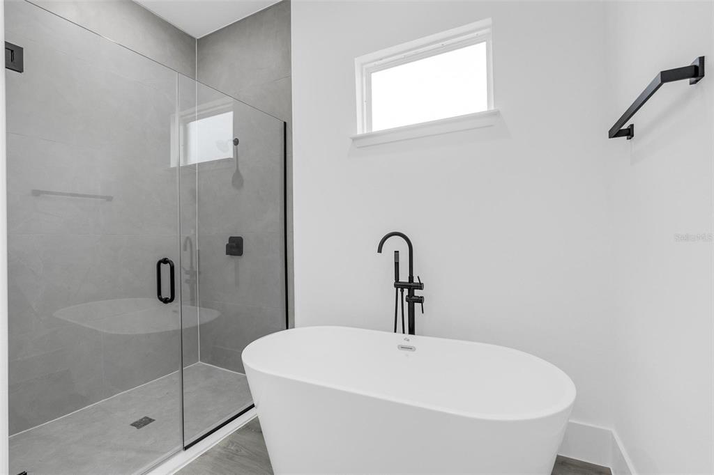 3428 Southwest 165th Loop Ocala, FL 34473 - Photo 28 of 43 a white bath tub sitting next to a shower