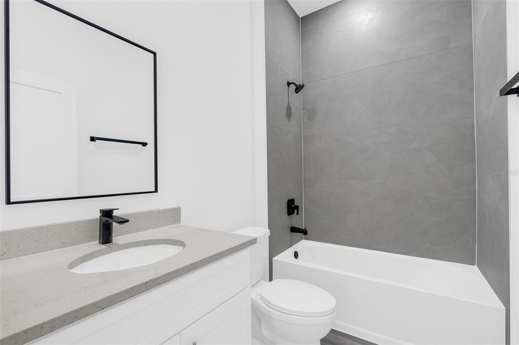 3428 Southwest 165th Loop Ocala, FL 34473 - Photo 29 of 43 a bathroom with a granite countertop sink toilet and shower