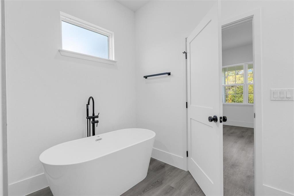 3428 Southwest 165th Loop Ocala, FL 34473 - Photo 30 of 43 a white bath tub sitting in a bathroom