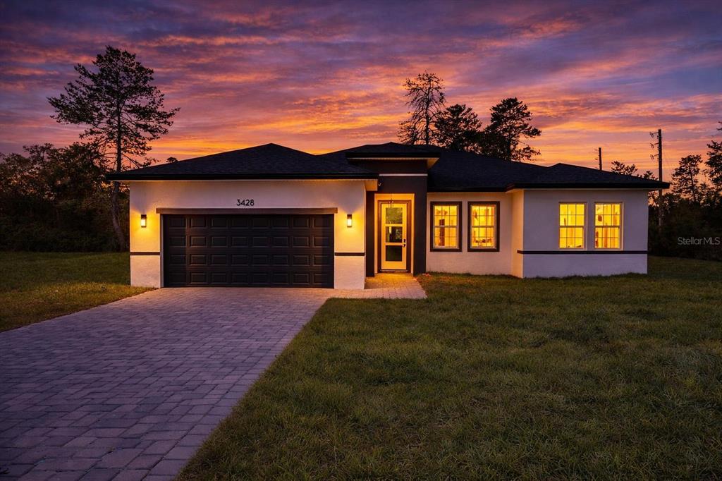 3428 Southwest 165th Loop Ocala, FL 34473 - Photo 3 of 43 a front view of a house having yard