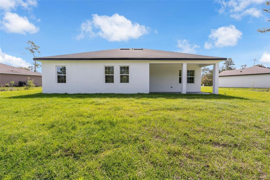 3428 Southwest 165th Loop Ocala, FL 34473 - Photo 33 of 43 a view of a house with a backyard
