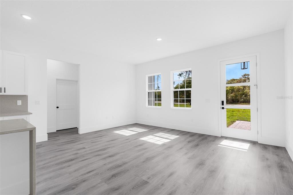 3428 Southwest 165th Loop Ocala, FL 34473 - Photo 7 of 43 a view of an empty room with a window and wooden floor