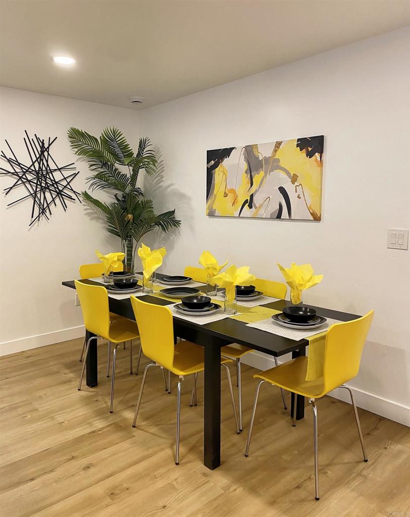 12401 Metate Lane Poway, CA 92064 - Photo 11 of 42 a view of a dining room with furniture and wooden floor