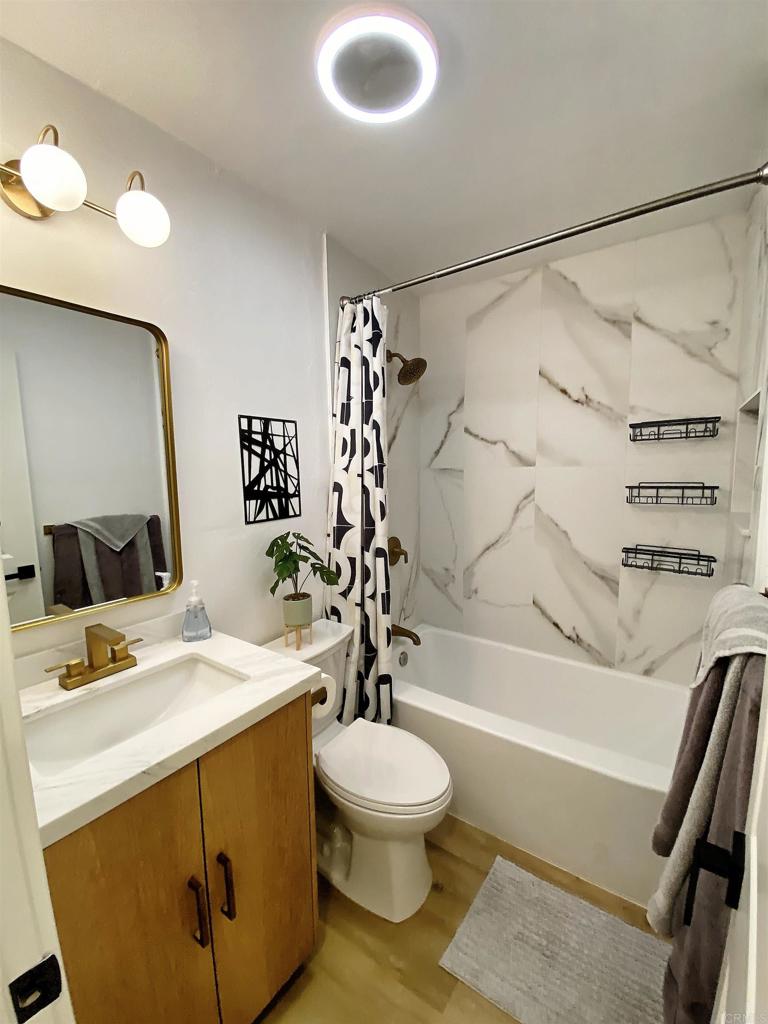 12401 Metate Lane Poway, CA 92064 - Photo 20 of 42 a bathroom with a sink a toilet and a bathtub