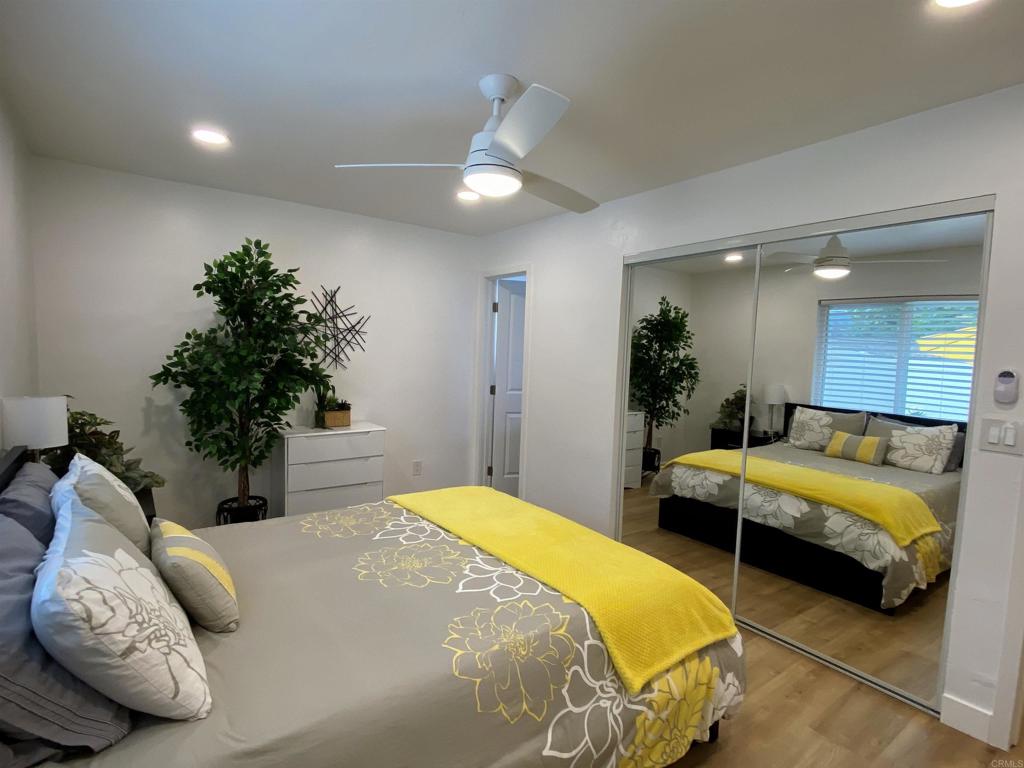 12401 Metate Lane Poway, CA 92064 - Photo 22 of 42 a bedroom with bed and a potted plant