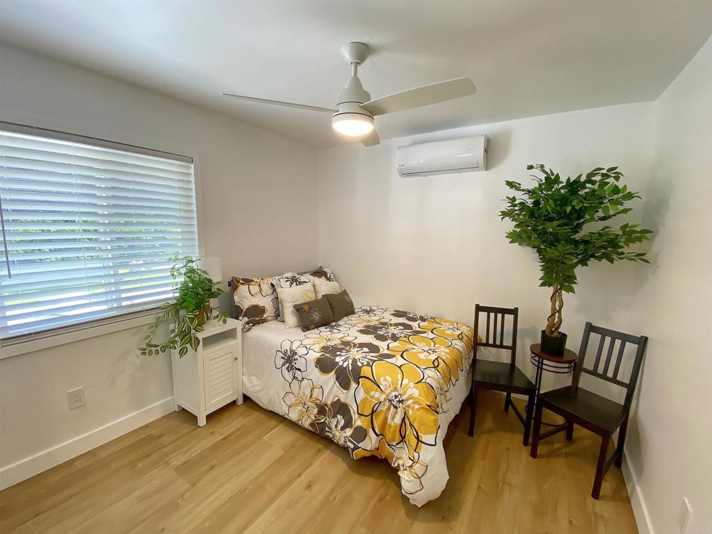 12401 Metate Lane Poway, CA 92064 - Photo 23 of 42 a bedroom with bed and a potted plant