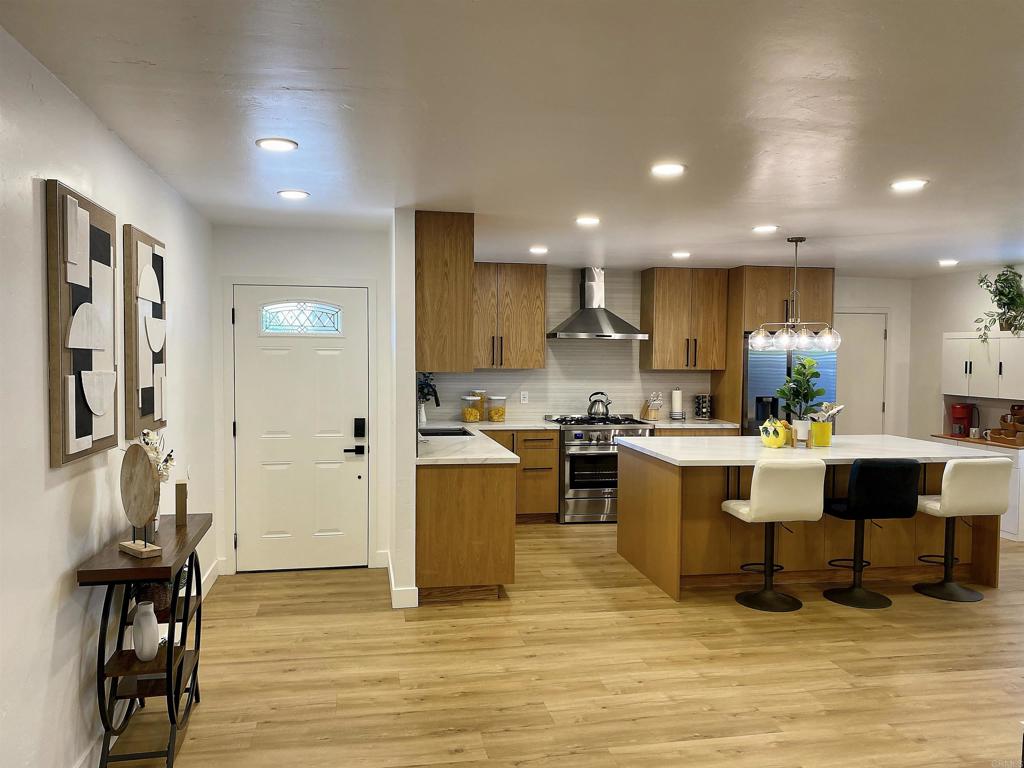 12401 Metate Lane Poway, CA 92064 - Photo 5 of 42 a kitchen with a sink cabinets and wooden floor