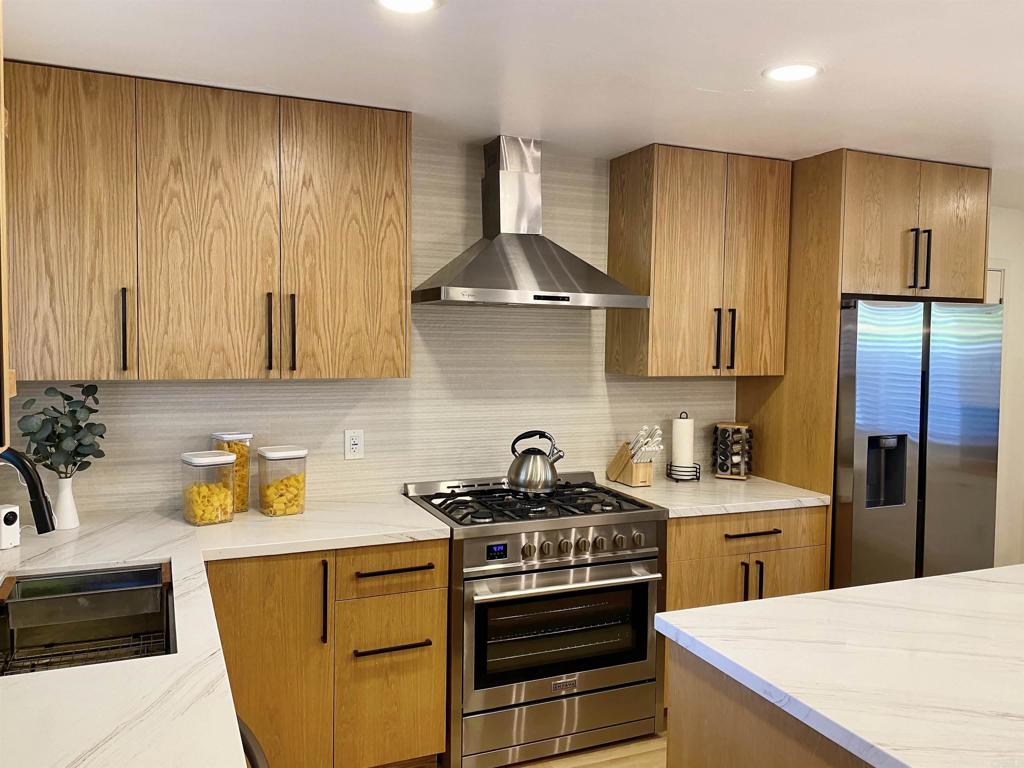 12401 Metate Lane Poway, CA 92064 - Photo 10 of 42 a kitchen with stainless steel appliances a stove a sink and a refrigerator