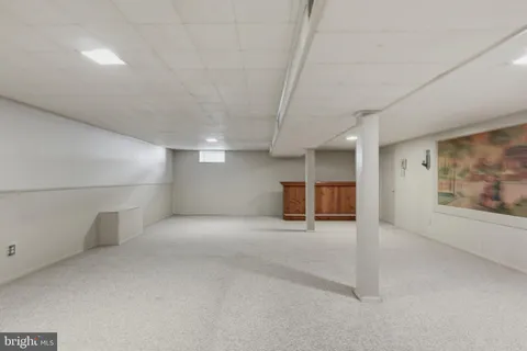 an empty room with fireplace and windows