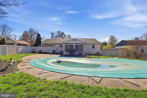 a aerial view of a house with a yard table and chairs