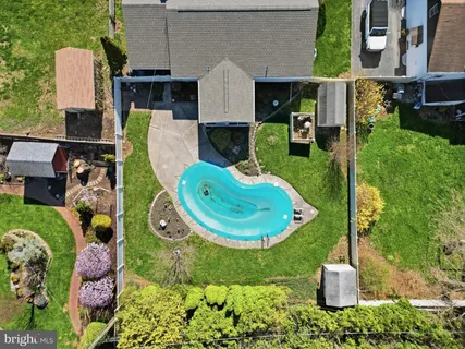 an aerial view of a house with swimming pool garden and patio