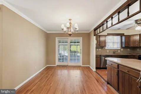 a view of a kitchen with a sink wooden floor and cabinets