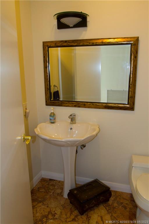 1790 Northwest River Trail Stuart, FL 34994 - Photo 17 of 44 a bathroom with a sink and a mirror