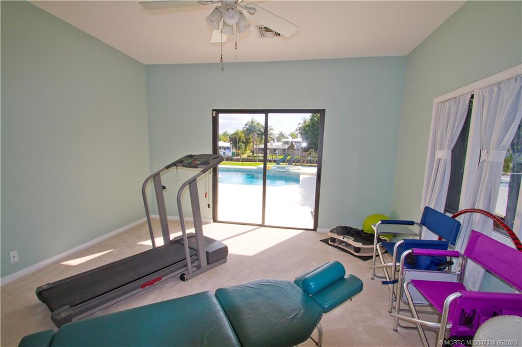 1790 Northwest River Trail Stuart, FL 34994 - Photo 19 of 44 a living room with furniture a large window and a chandelier