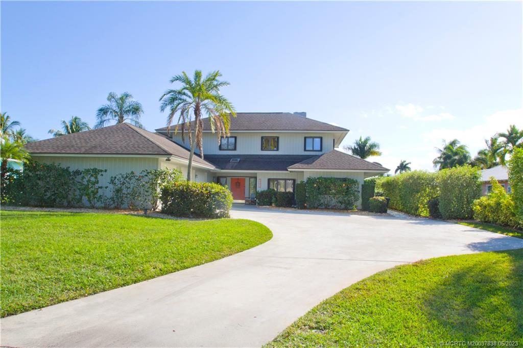 1790 Northwest River Trail Stuart, FL 34994 - Photo 2 of 44 a front view of a house with a yard