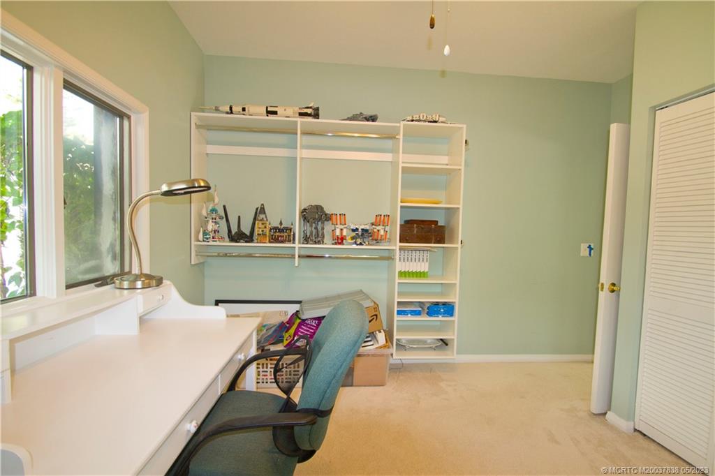 1790 Northwest River Trail Stuart, FL 34994 - Photo 21 of 44 a room with a bed and a table