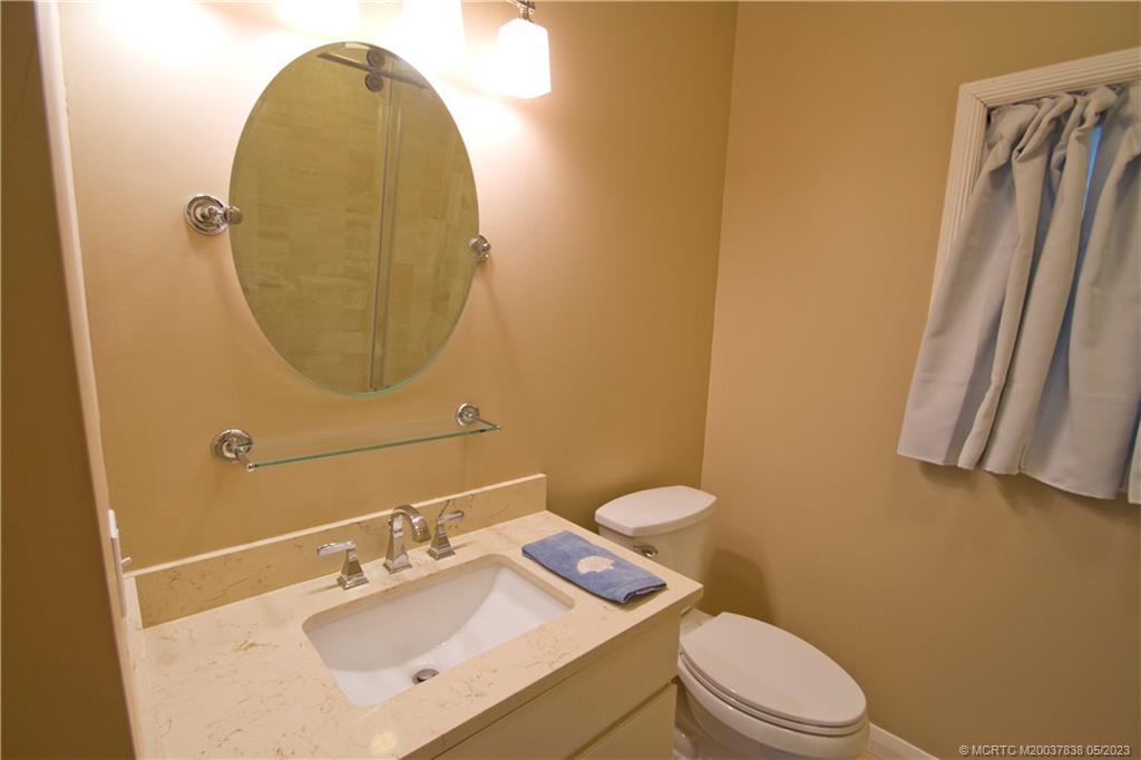 1790 Northwest River Trail Stuart, FL 34994 - Photo 22 of 44 a bathroom with a sink mirror vanity and toilet
