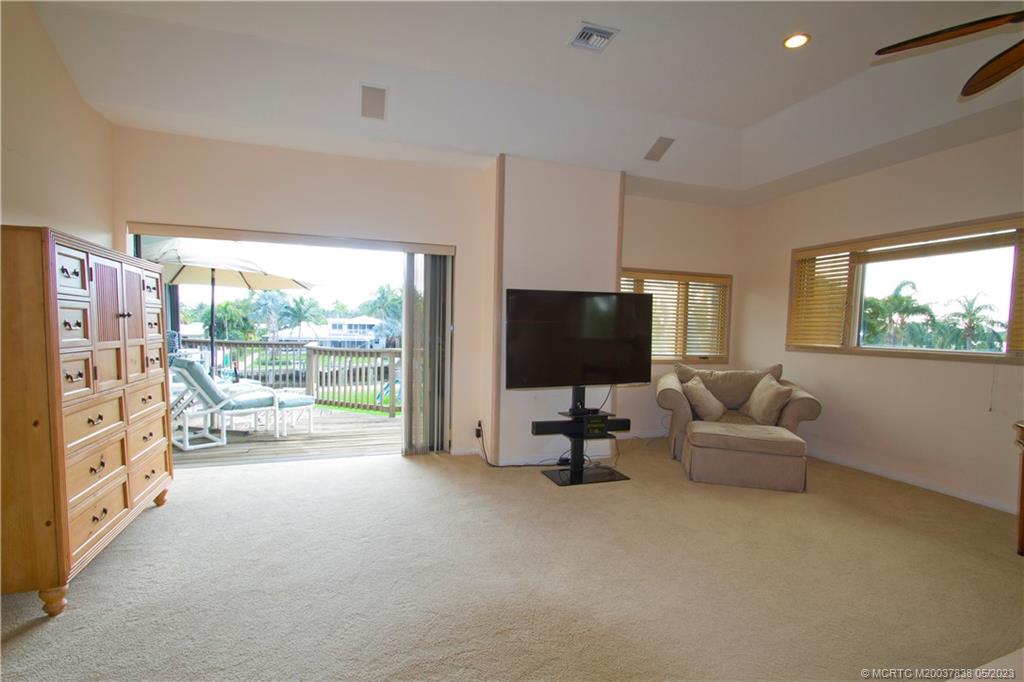 1790 Northwest River Trail Stuart, FL 34994 - Photo 29 of 44 a living room with furniture and a flat screen tv
