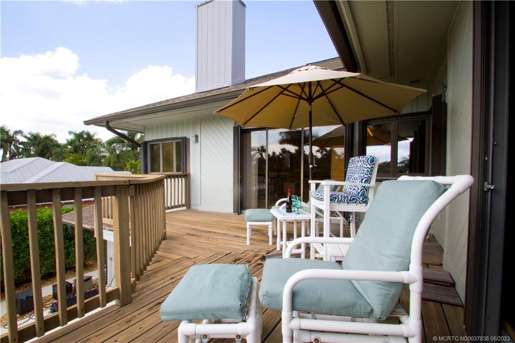 1790 Northwest River Trail Stuart, FL 34994 - Photo 31 of 44 a view of a patio with a table and chairs under an umbrella