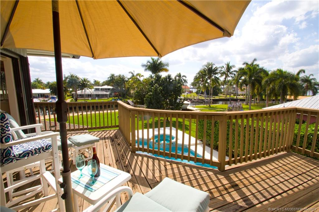 1790 Northwest River Trail Stuart, FL 34994 - Photo 32 of 44 a view of a balcony with wooden floor and outdoor seating