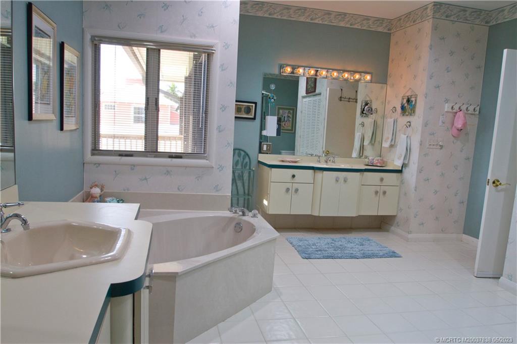 1790 Northwest River Trail Stuart, FL 34994 - Photo 33 of 44 a bathroom with a tub sink and mirror