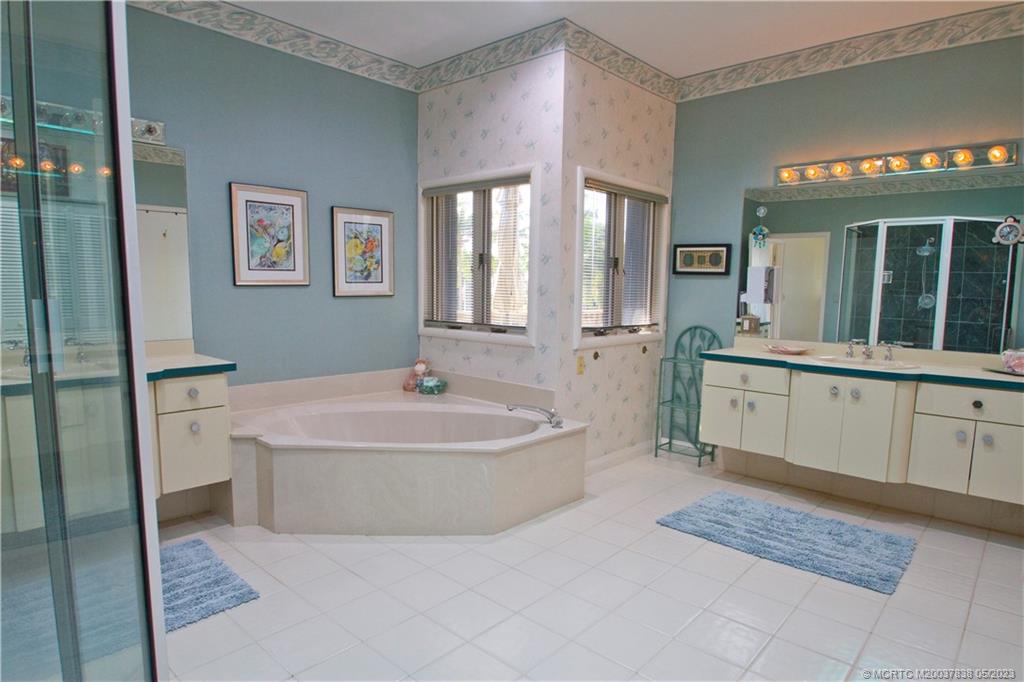 1790 Northwest River Trail Stuart, FL 34994 - Photo 34 of 44 a spacious bathroom with a tub sink and mirror