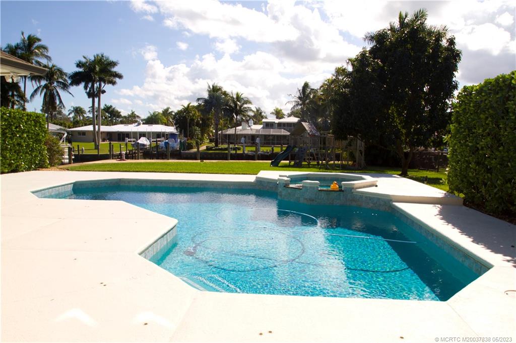 1790 Northwest River Trail Stuart, FL 34994 - Photo 43 of 44 a swimming pool with outdoor seating and yard