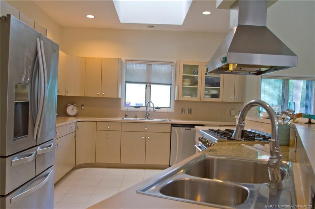 1790 Northwest River Trail Stuart, FL 34994 - Photo 6 of 44 a kitchen with granite countertop a sink stainless steel appliances and cabinets