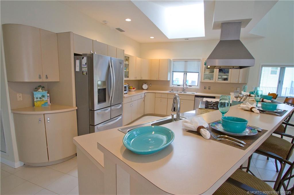 1790 Northwest River Trail Stuart, FL 34994 - Photo 8 of 44 a kitchen with a table chairs stove and refrigerator