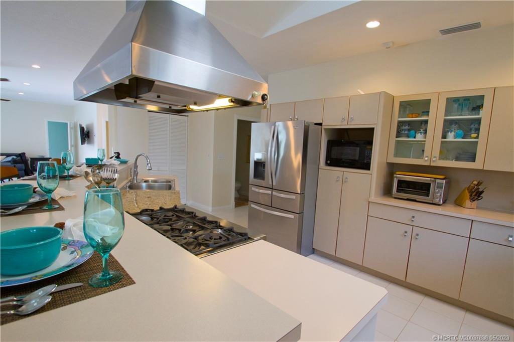 1790 Northwest River Trail Stuart, FL 34994 - Photo 9 of 44 a kitchen with stainless steel appliances a stove a refrigerator and a sink