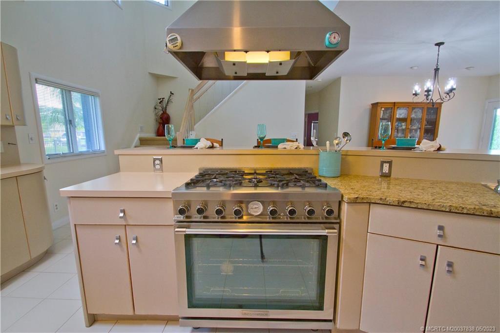 1790 Northwest River Trail Stuart, FL 34994 - Photo 10 of 44 a kitchen with granite countertop a stove and a sink