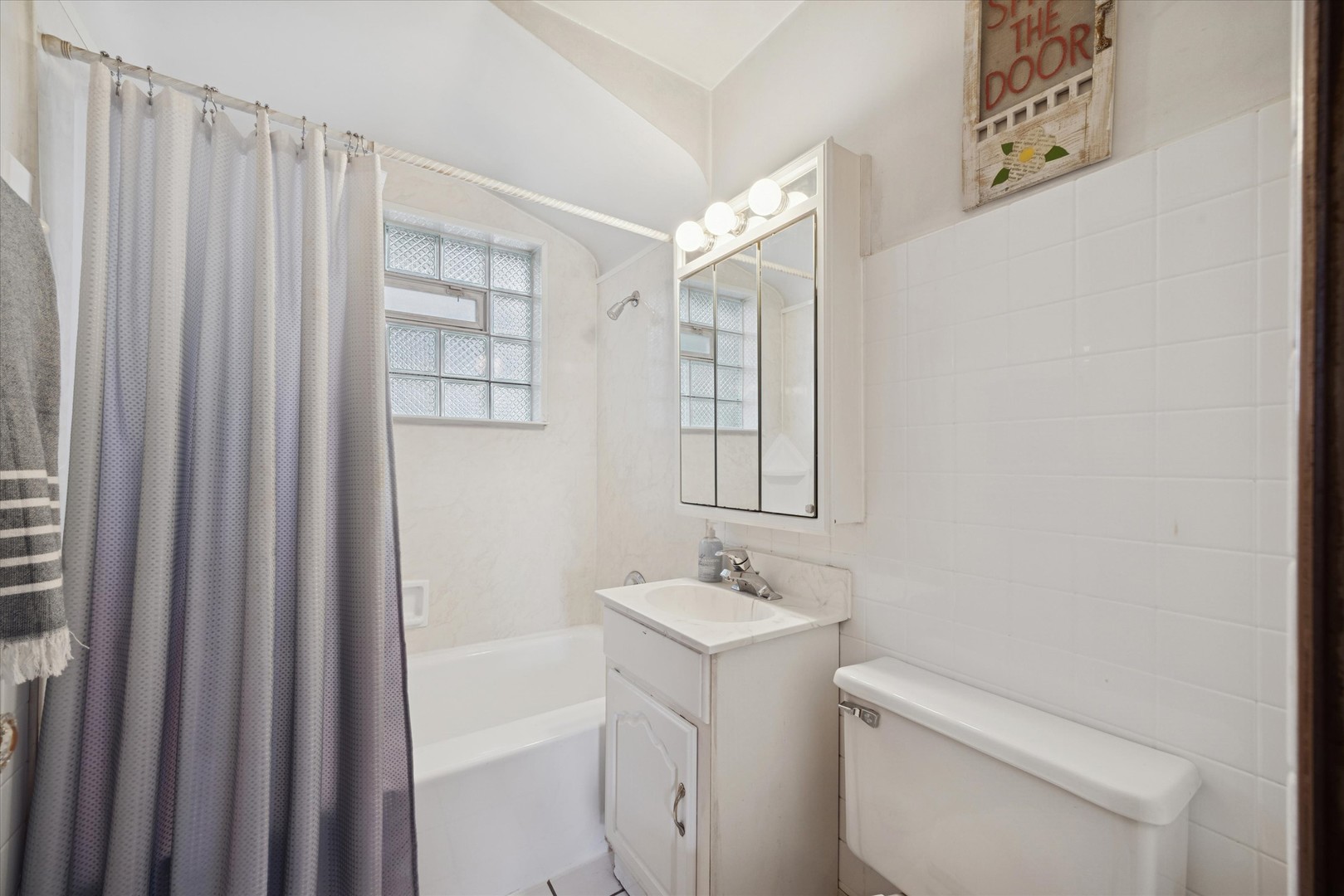 3334 Prairie Avenue Brookfield, IL 60513 - Photo 12 of 18 a bathroom with a sink a toilet and shower