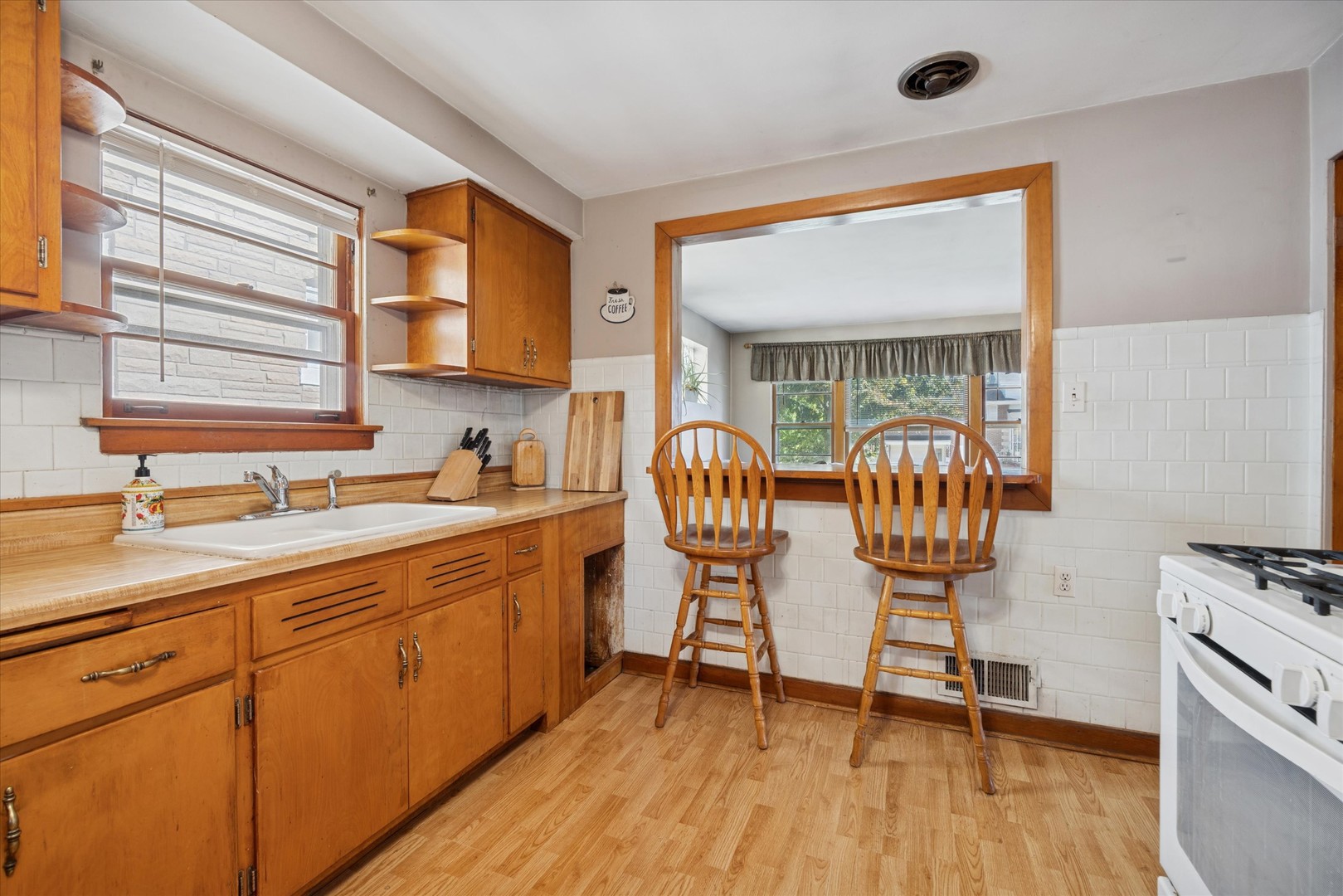 3334 Prairie Avenue Brookfield, IL 60513 - Photo 4 of 18 a kitchen with stainless steel appliances granite countertop a sink a stove and a wooden floors