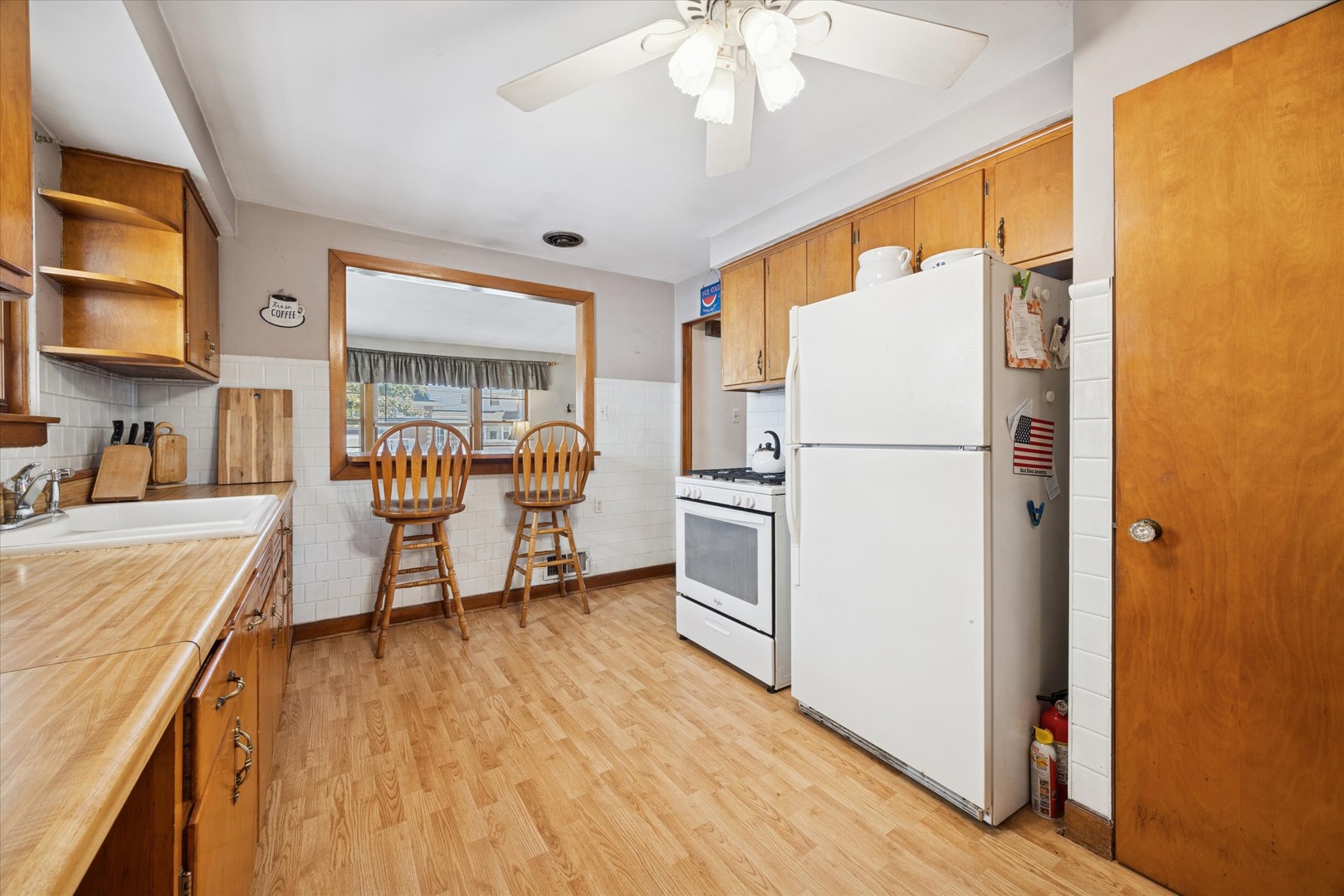3334 Prairie Avenue Brookfield, IL 60513 - Photo 6 of 18 a kitchen with stainless steel appliances a refrigerator and a stove top oven