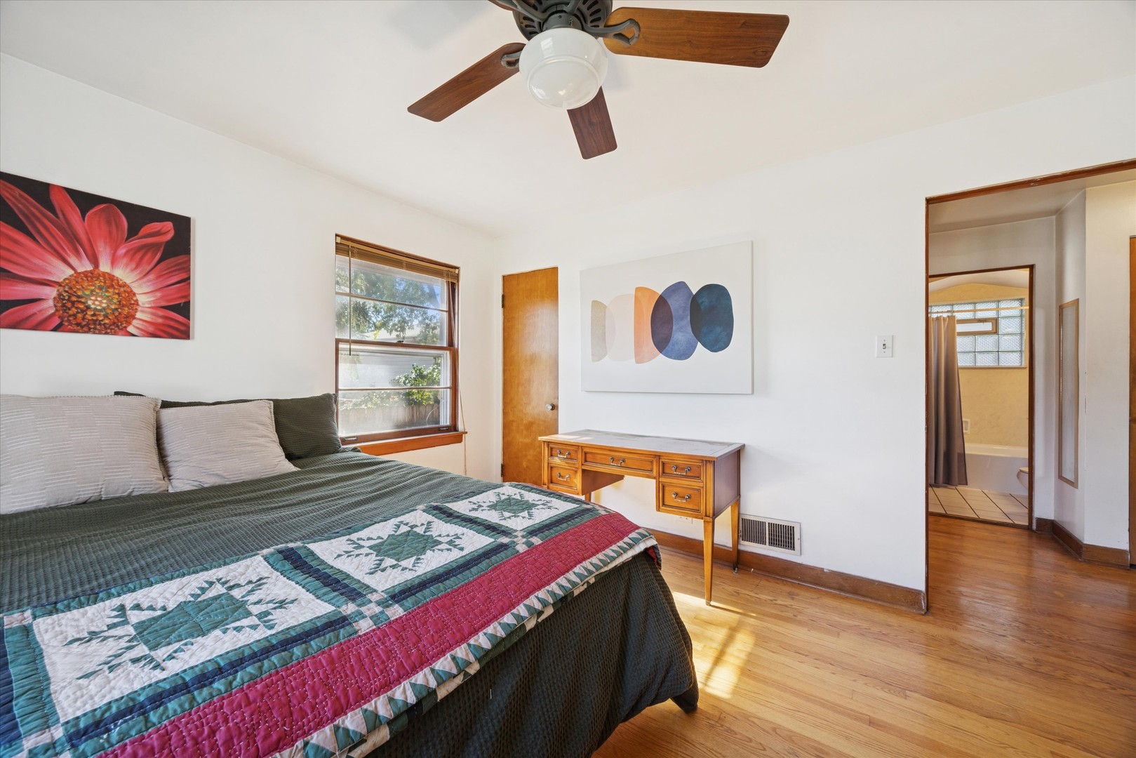 3334 Prairie Avenue Brookfield, IL 60513 - Photo 9 of 18 a bedroom with a bed and a lamp on dresser with wooden floor