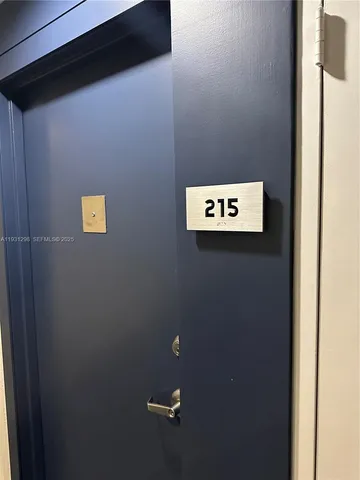 a living room with furniture a fireplace and a large window