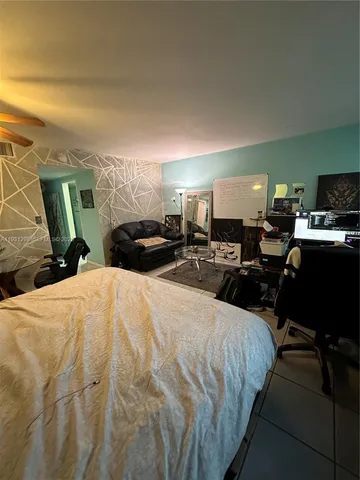 a bed room with a bed window and a chair