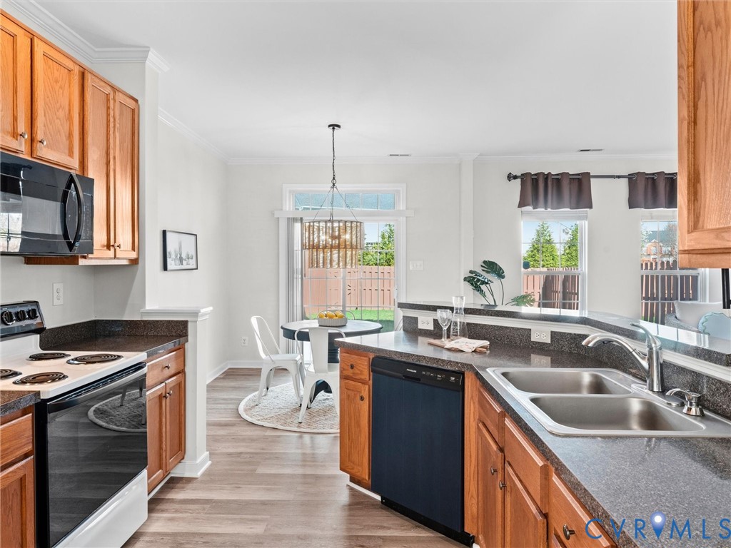 9524 Spring Moss Terrace, Unit 9524 Glen Allen, VA 23060 - Photo 19 of 41 a kitchen with a sink stove and cabinets