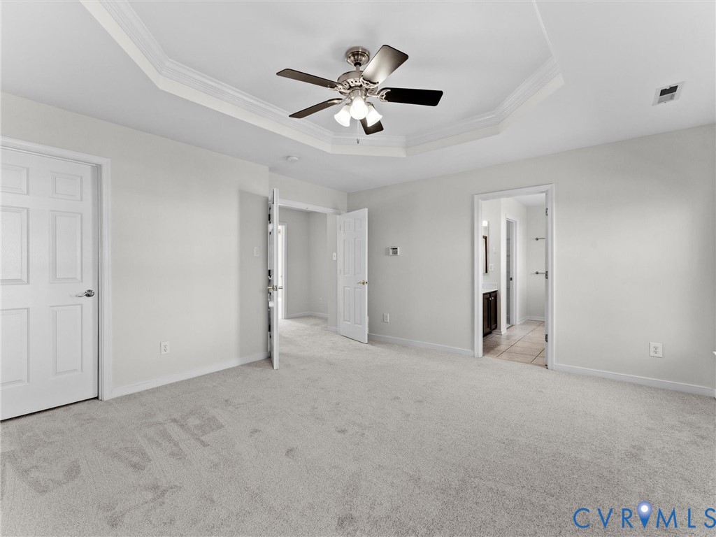 9524 Spring Moss Terrace, Unit 9524 Glen Allen, VA 23060 - Photo 23 of 41 an empty room with chandelier fan and windows