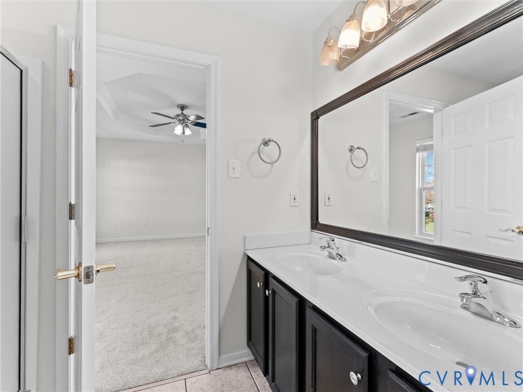 9524 Spring Moss Terrace, Unit 9524 Glen Allen, VA 23060 - Photo 26 of 41 a bathroom with a double vanity sink and mirror