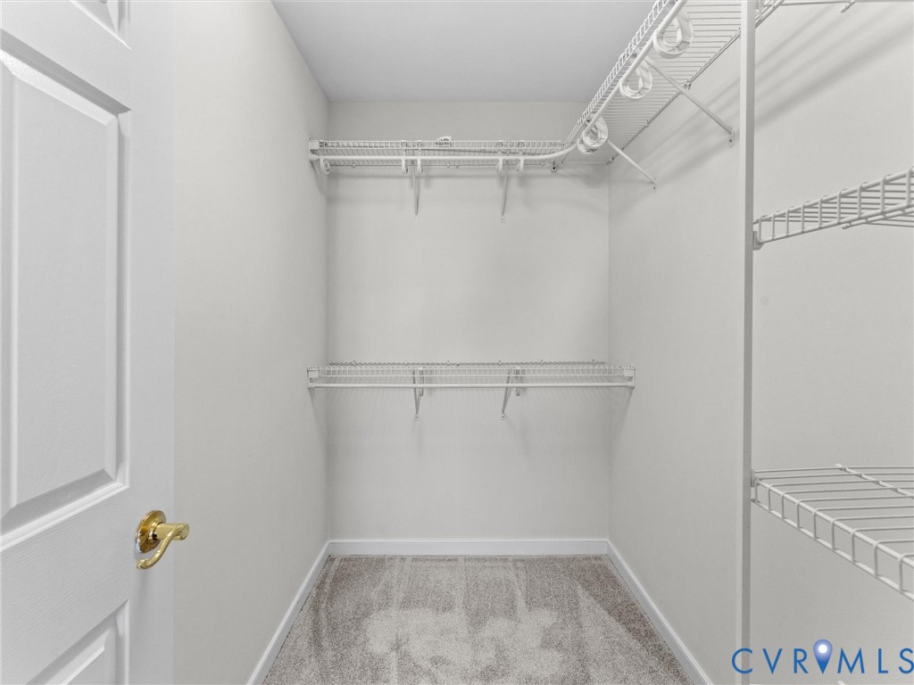 9524 Spring Moss Terrace, Unit 9524 Glen Allen, VA 23060 - Photo 31 of 41 a view of walk in closet with empty racks