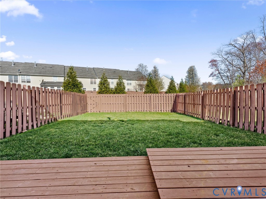 9524 Spring Moss Terrace, Unit 9524 Glen Allen, VA 23060 - Photo 40 of 41 a view of a backyard with wooden fence