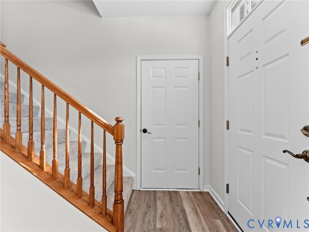 9524 Spring Moss Terrace, Unit 9524 Glen Allen, VA 23060 - Photo 7 of 41 a view of a hallway with wooden floor and staircase