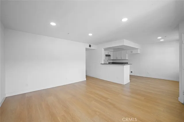 a view of a kitchen with a sink and a refrigerator
