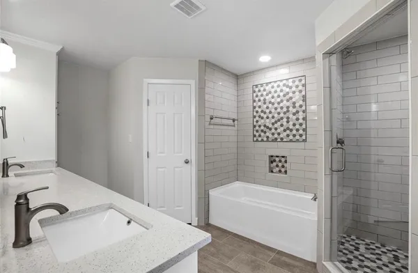 a bathroom with a bathtub and a sink