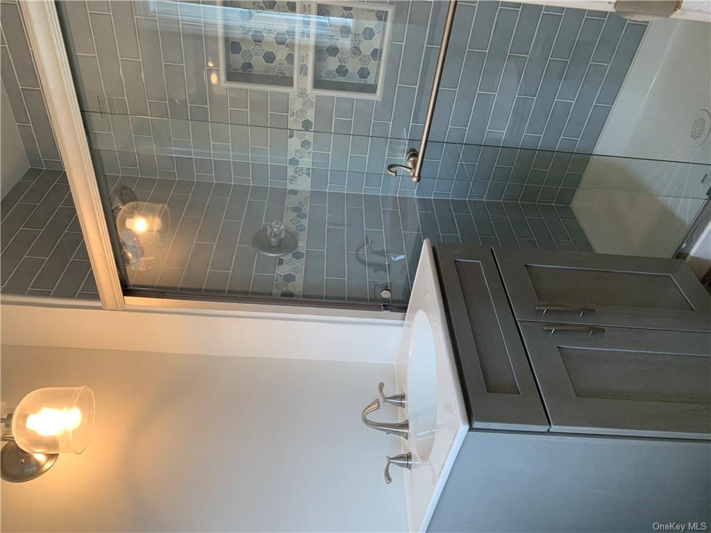 492 Main Street West Harrison, NY 10604 - Photo 9 of 10 Bathroom with vanity and a shower with door
