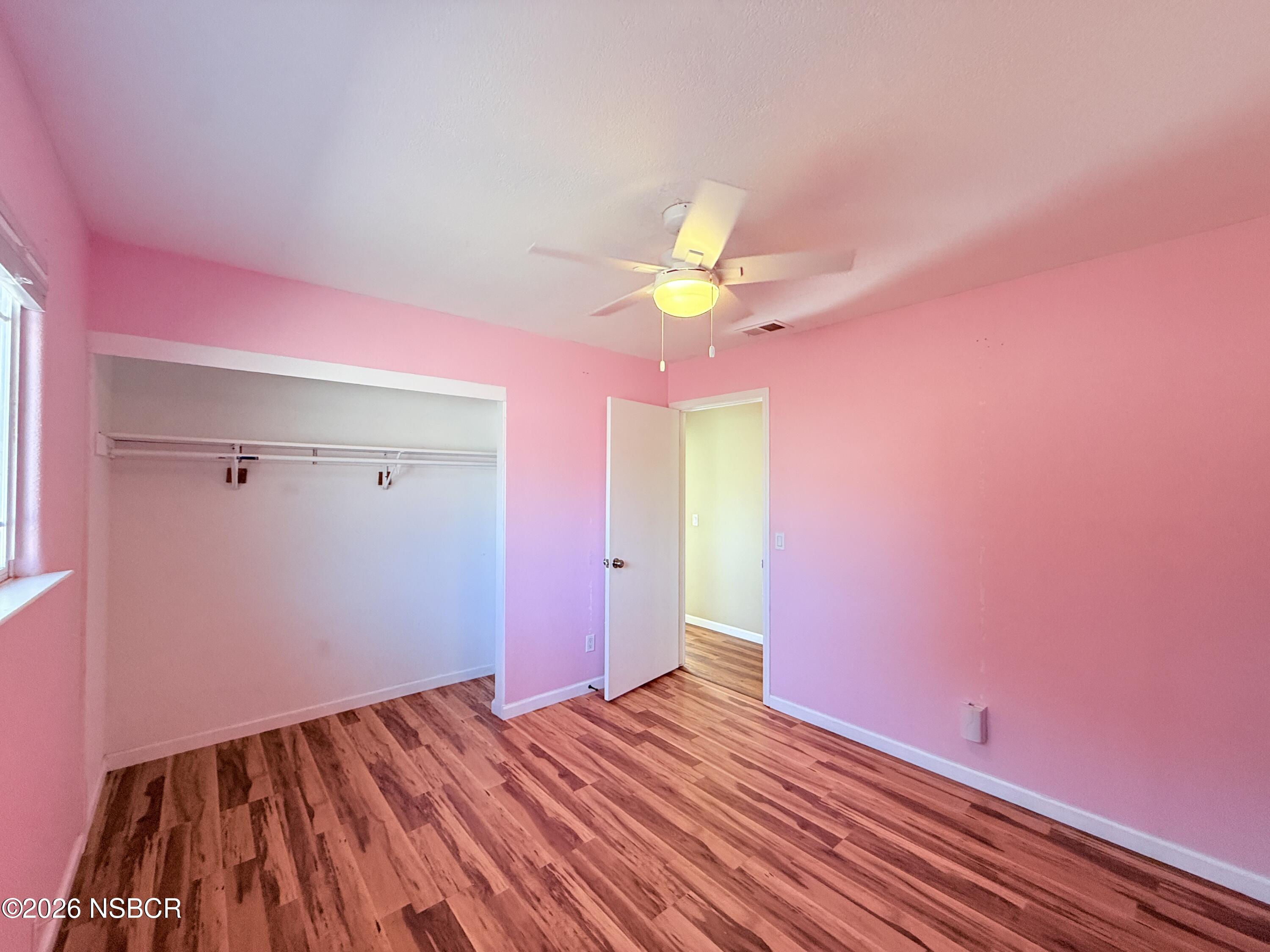 4031 Hillview Road Santa Maria, CA 93455 - Photo 5 of 16 a view of a livingroom with wooden floor and a ceiling fan