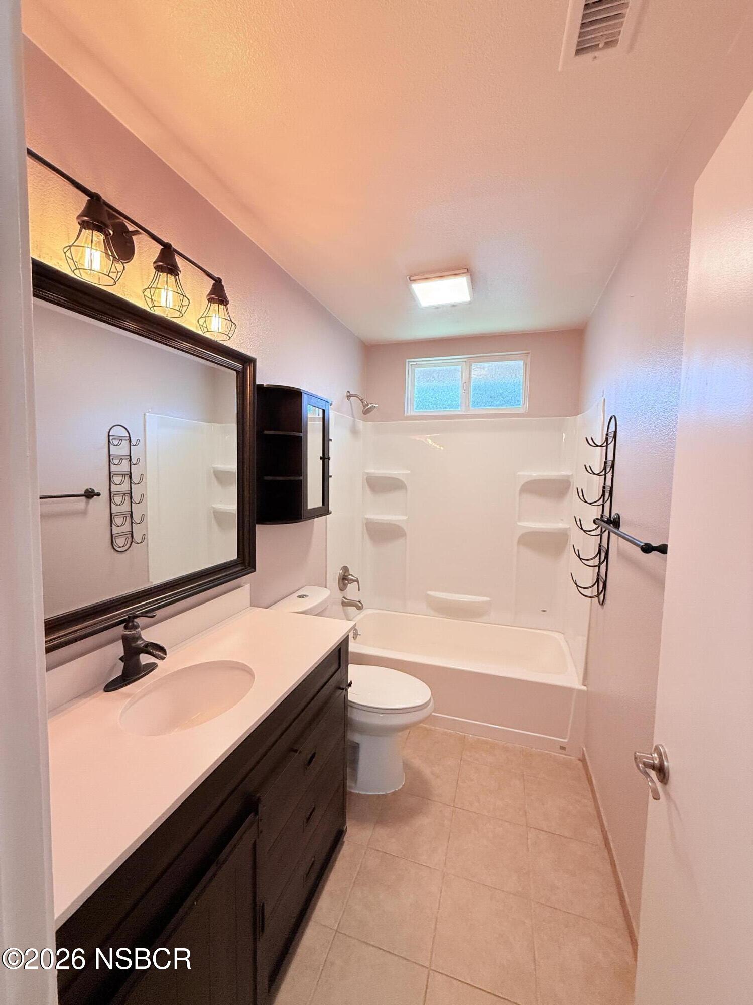 4031 Hillview Road Santa Maria, CA 93455 - Photo 7 of 16 a bathroom with a sink a toilet and mirror