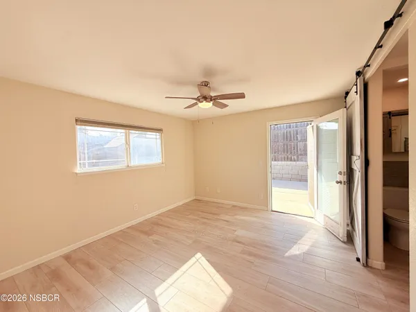 a view of a room with a ceiling fan